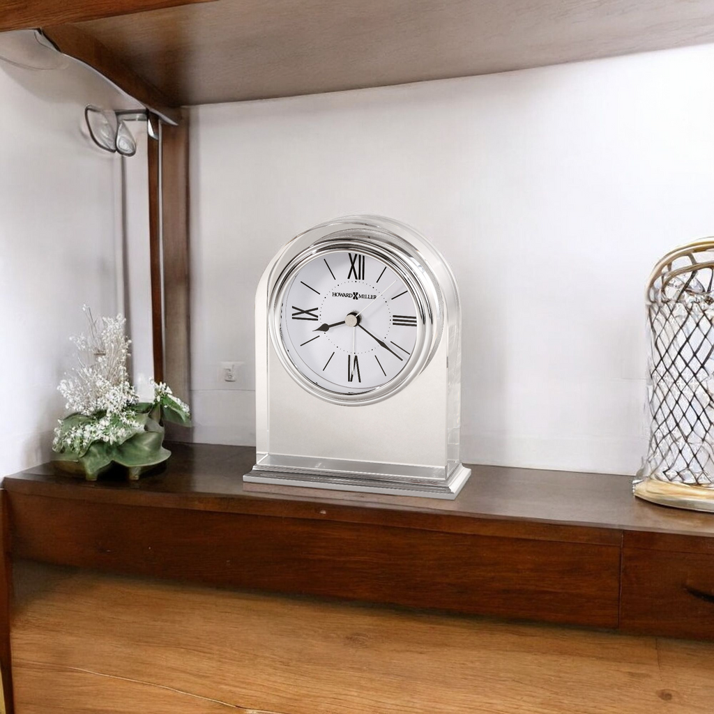 A decorative clock on a wooden shelf