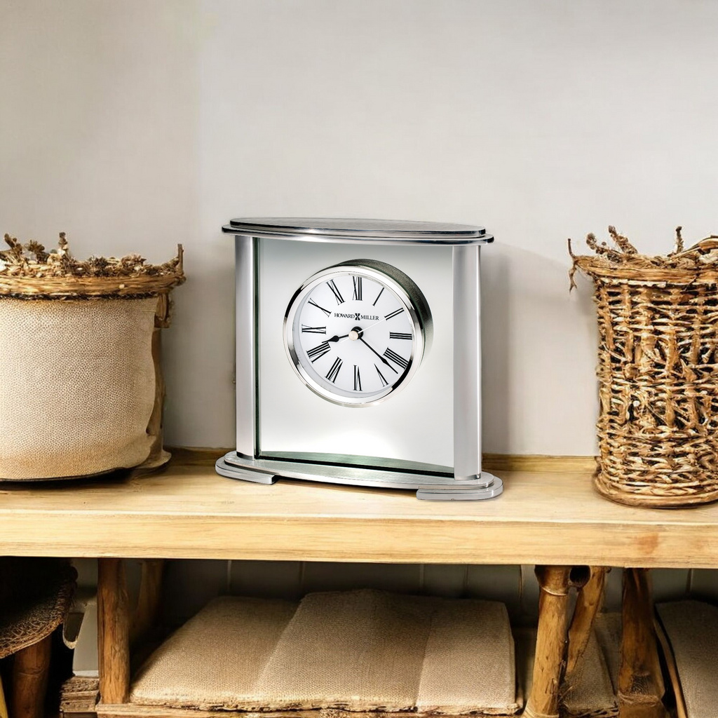 A decorative clock displayed on a wooden shelf alongside two woven baskets.