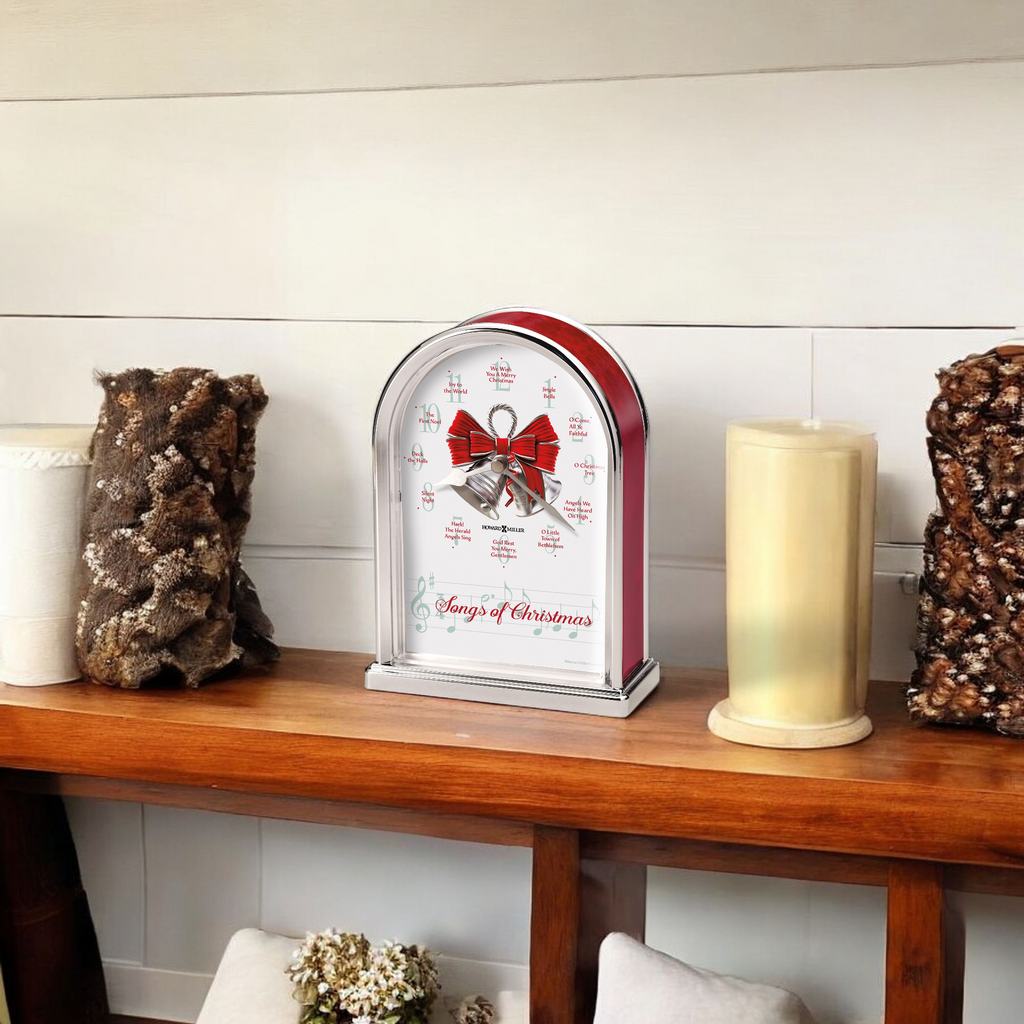 A festive clock with a red bow on a wooden shelf, surrounded by decorative candles and rustic accents.