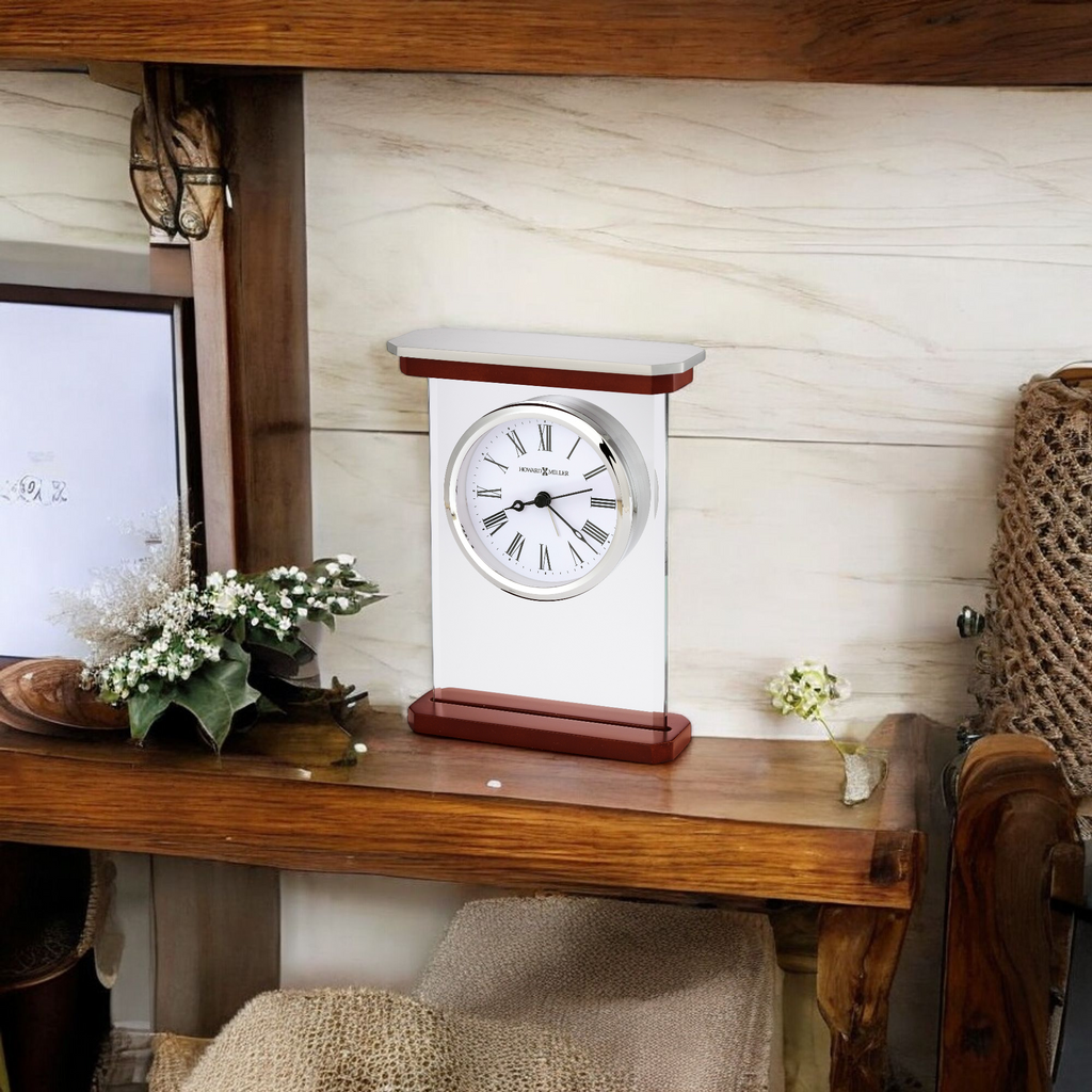 A decorative clock on a wooden shelf with flowers and a rustic background.