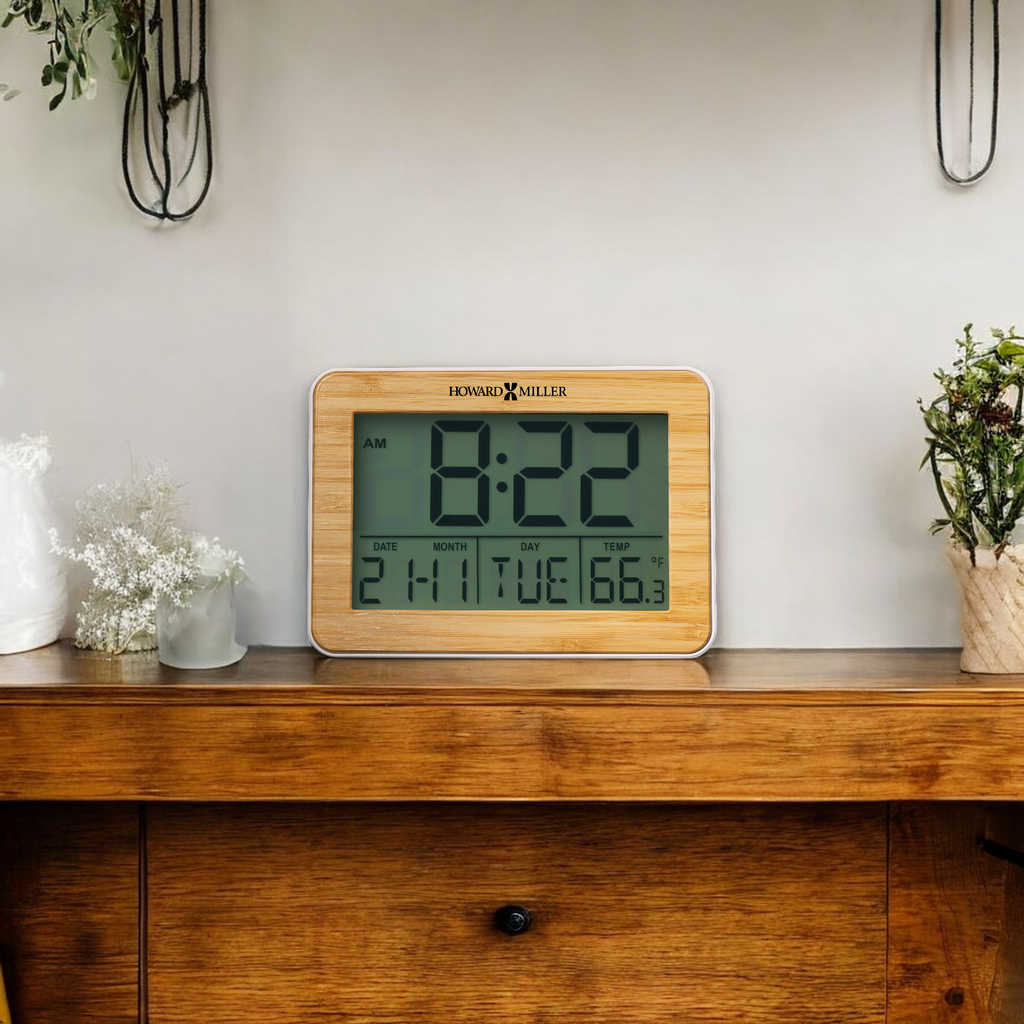 Digital clock displaying time, date, and temperature on a wooden shelf