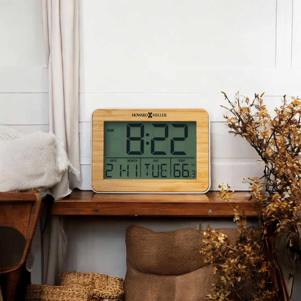 Digital clock displaying the time 8:22 AM on a wooden shelf with decorative elements.