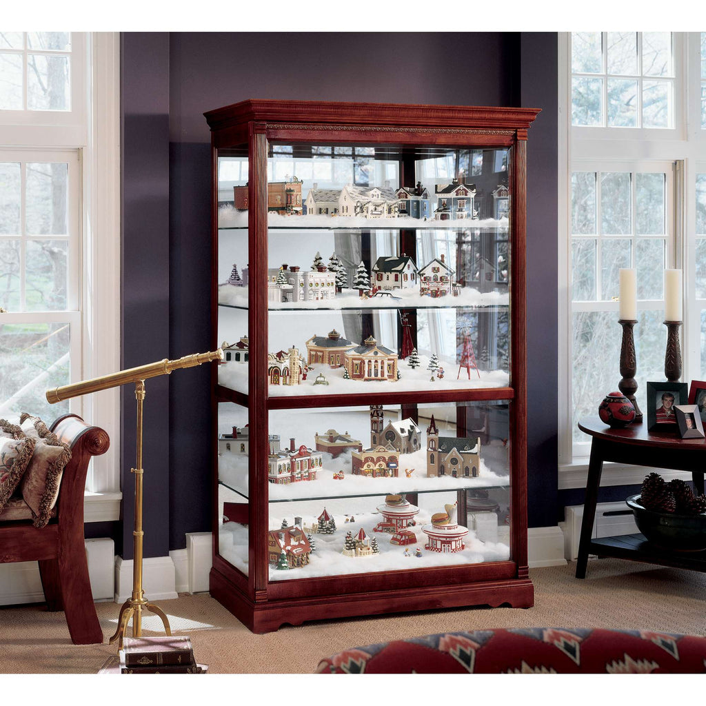 Display cabinet filled with decorative village figurines and Christmas scenes.