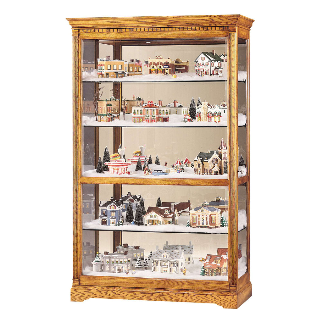 Display case filled with miniature festive village scenes and houses