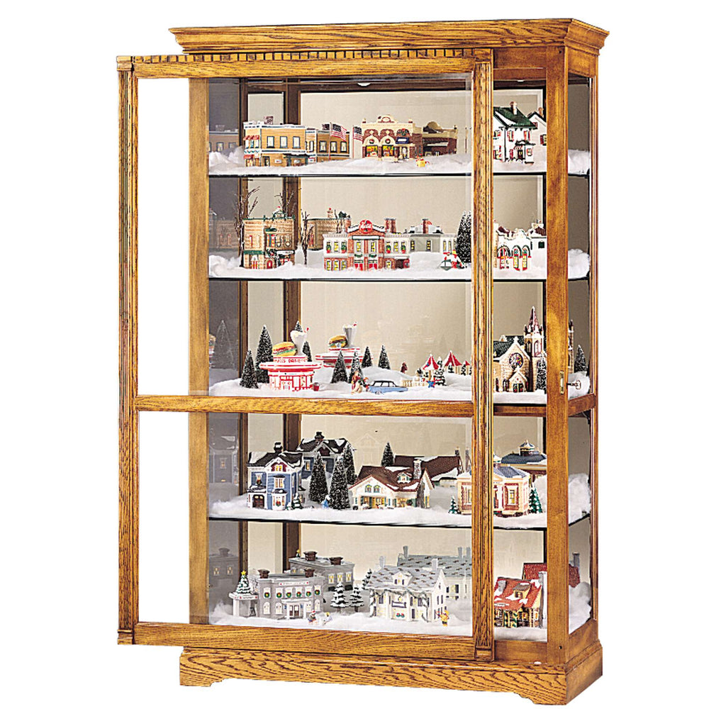 A wooden display cabinet filled with miniature festive buildings and decorations.