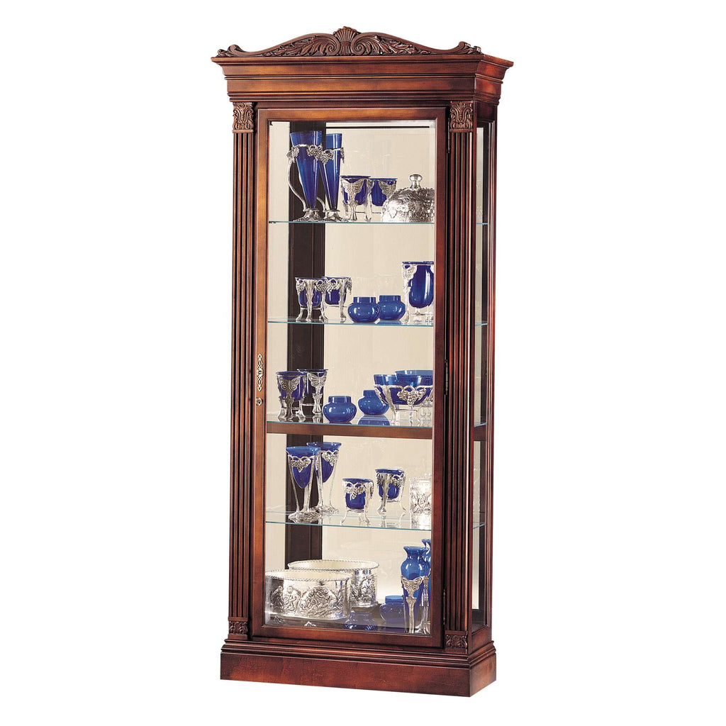 A wooden display cabinet showcasing various blue and clear glassware.
