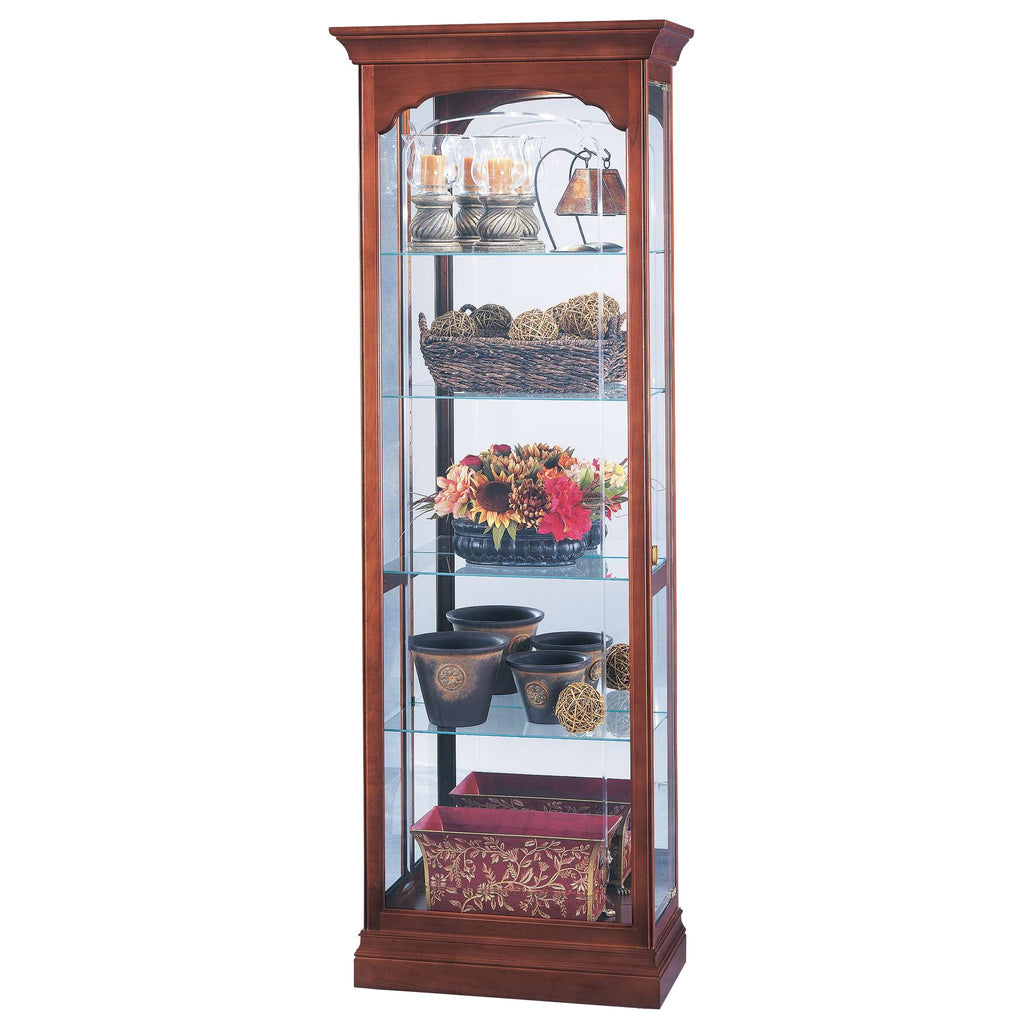 A tall wooden display cabinet with glass shelves showcasing decorative items and floral arrangements.
