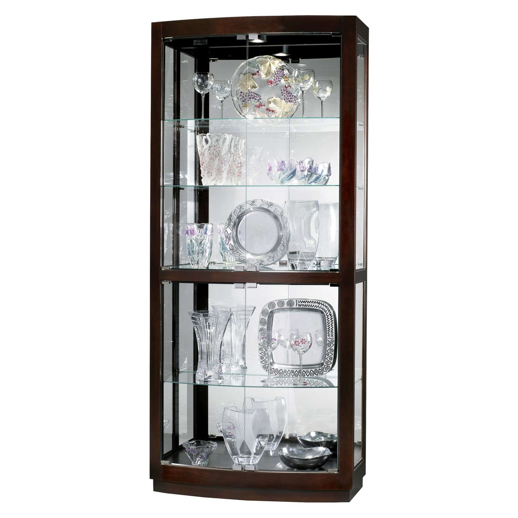 A glass display cabinet featuring various pieces of crystal and decorative glassware.