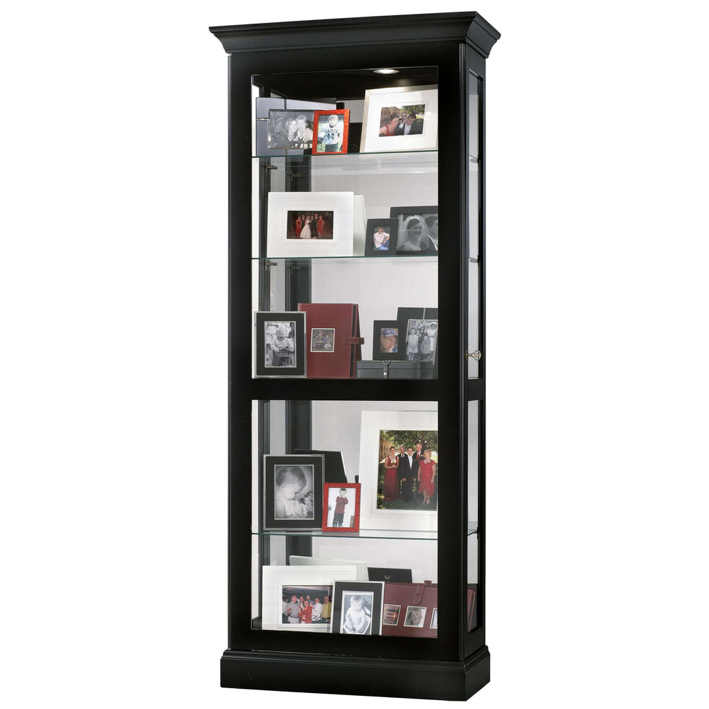 A tall black display cabinet filled with framed photographs.