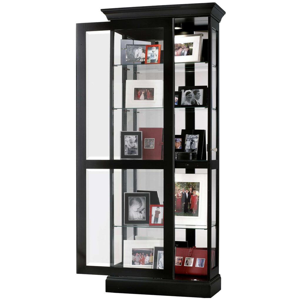 A tall display cabinet with glass doors, showcasing various picture frames and photographs.