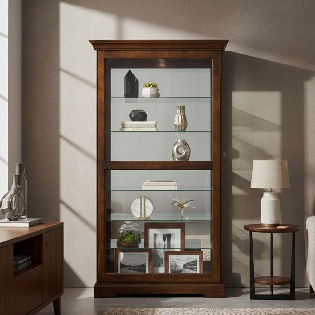 Wooden display cabinet with glass shelves featuring decorative items and picture frames.