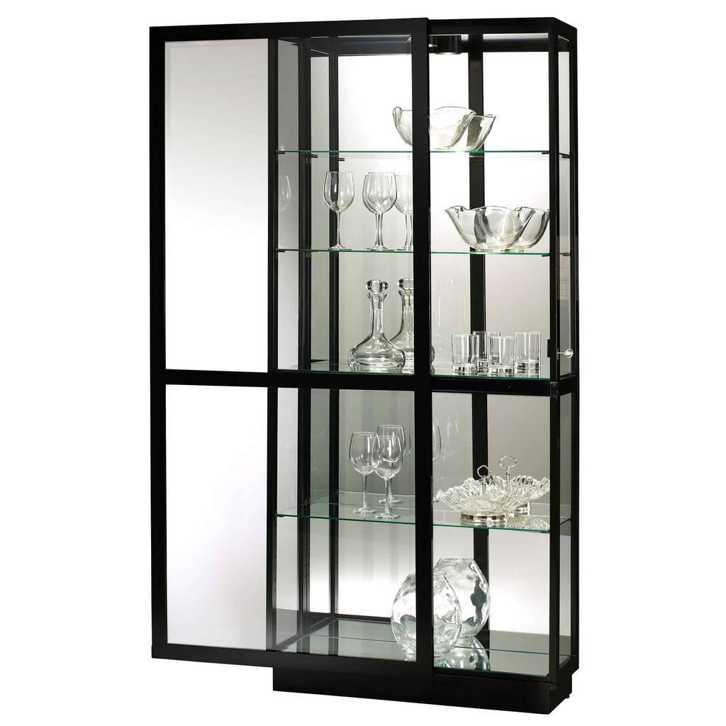 A modern glass display cabinet with black frame showcasing various glassware.