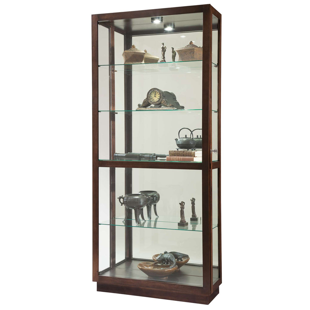 A wooden display cabinet with glass shelves showcasing various decorative artifacts.
