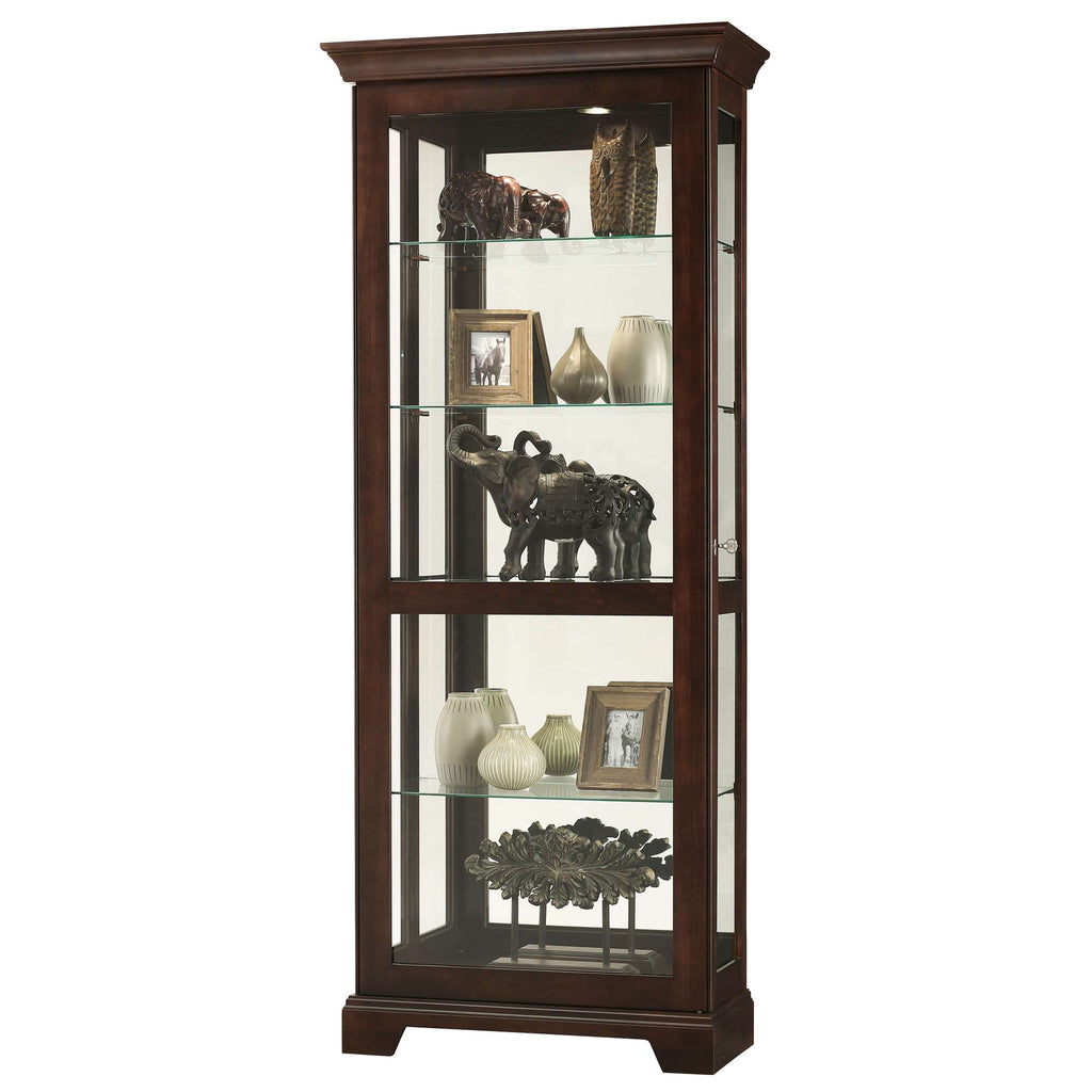 A tall wooden display cabinet with glass shelves showcasing decorative items and framed pictures.
