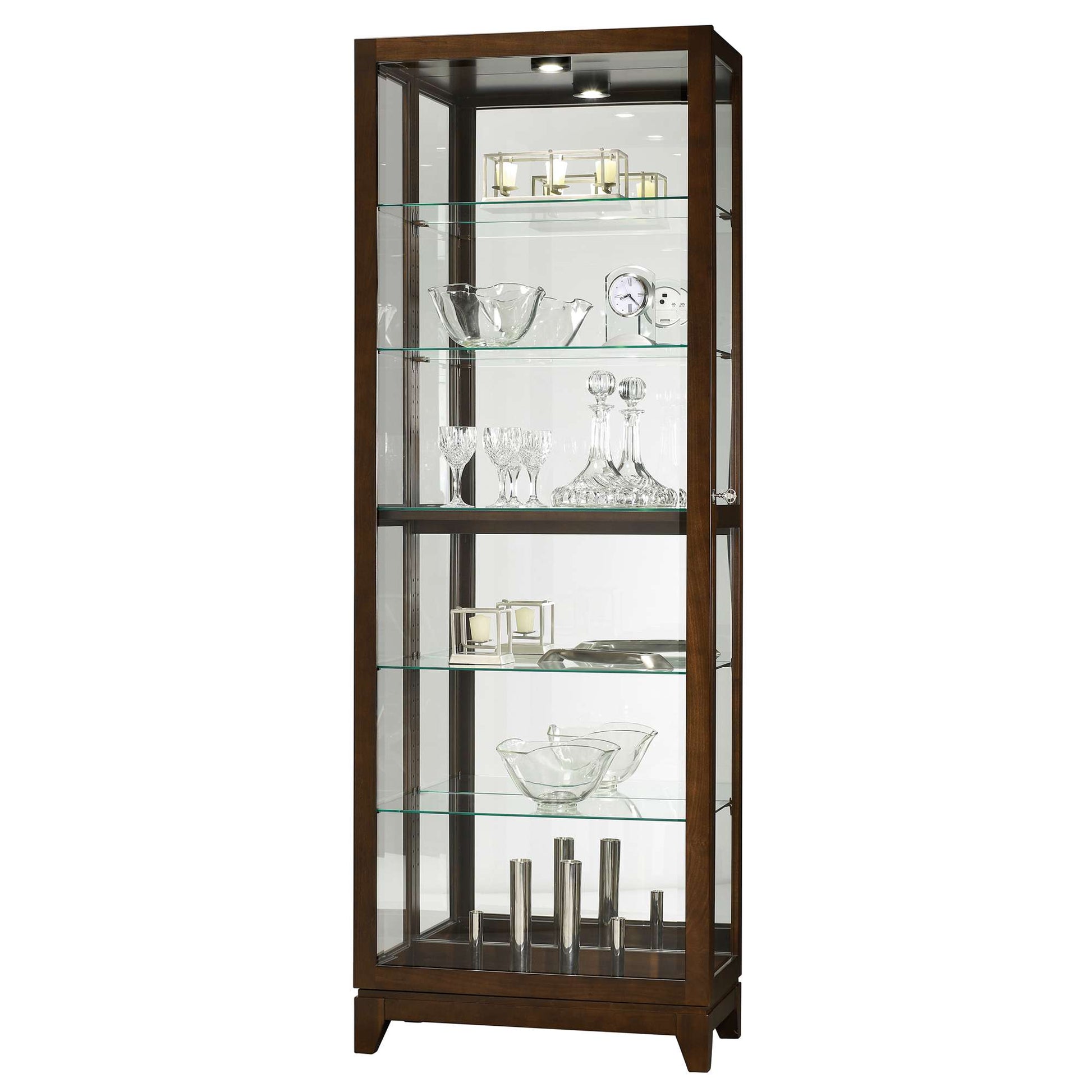 A tall wooden display cabinet with glass shelves showcasing various glassware and decorative items.