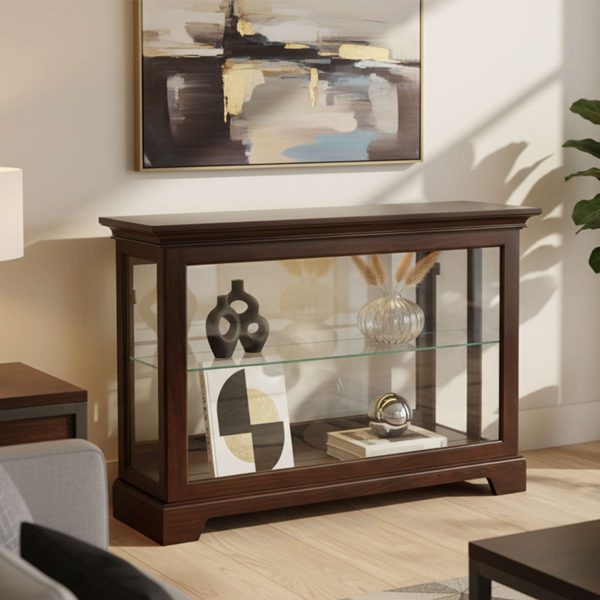 A stylish wooden display cabinet with glass shelves, showcasing decorative items, in a modern living room.