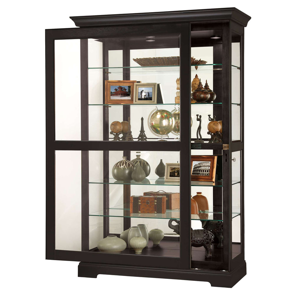 A modern display cabinet featuring glass shelves and various decorative items and photographs inside.