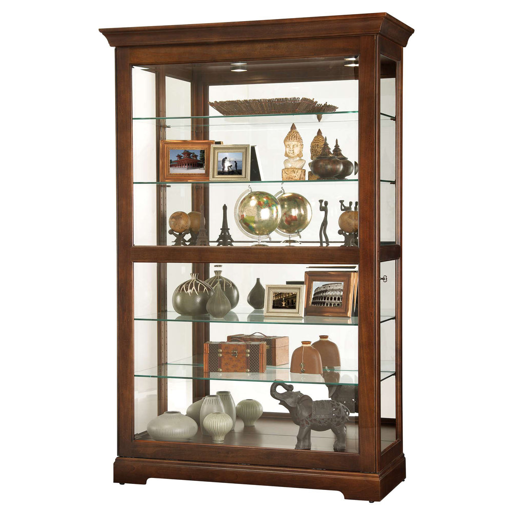 A wooden display cabinet with glass shelves showcasing various decorative items and photographs.
