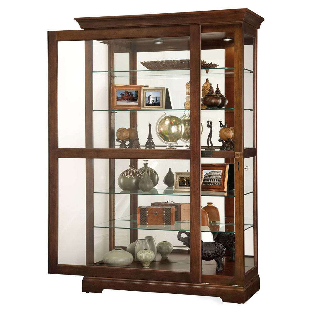 A wooden display cabinet featuring glass shelves and various decorative items.