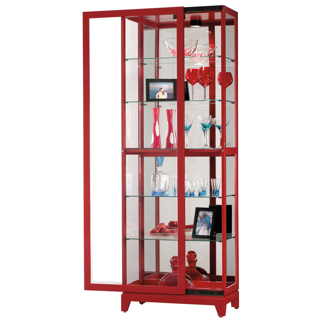 A modern red display cabinet with glass shelves showcasing decorative items and photos.