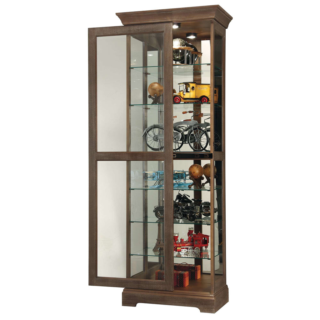 A wooden display cabinet with glass doors showcasing various collectibles and models.