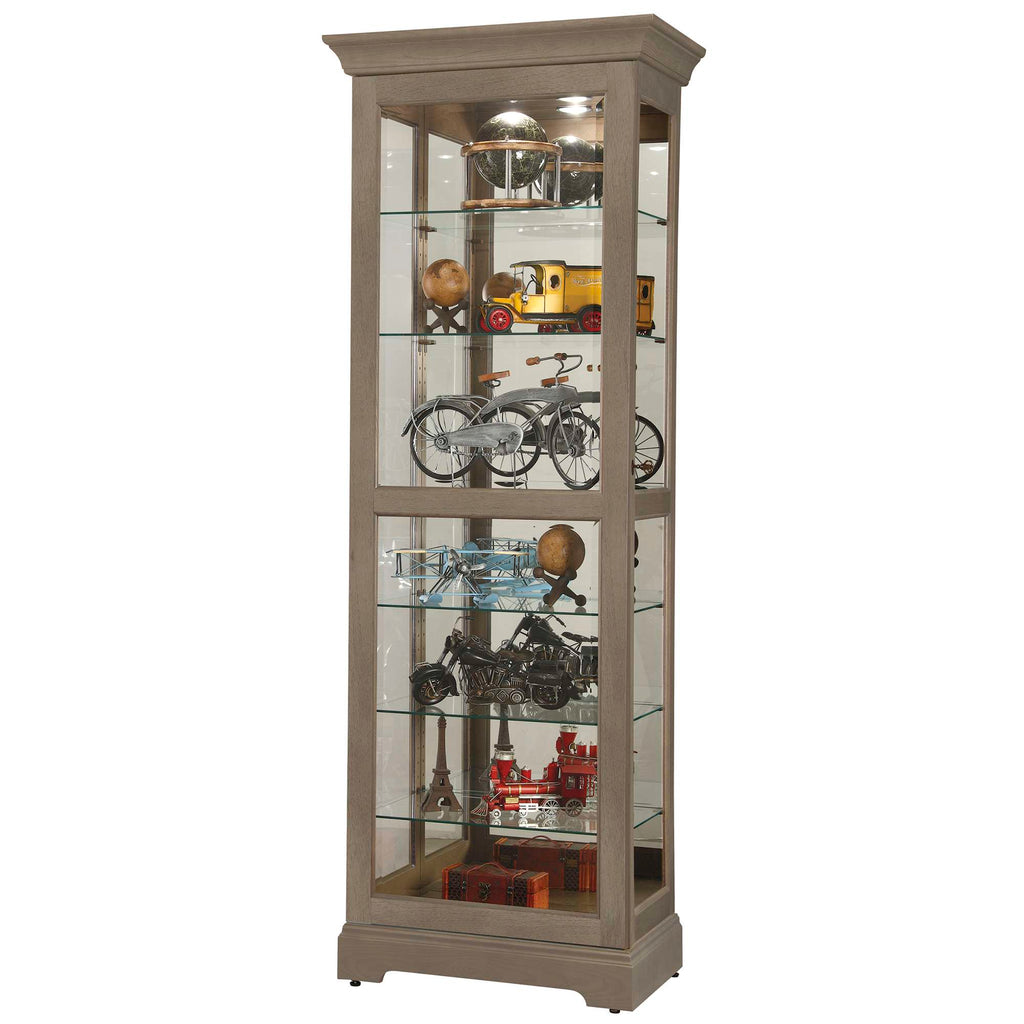 A tall glass display cabinet showcasing various vintage collectibles and models.