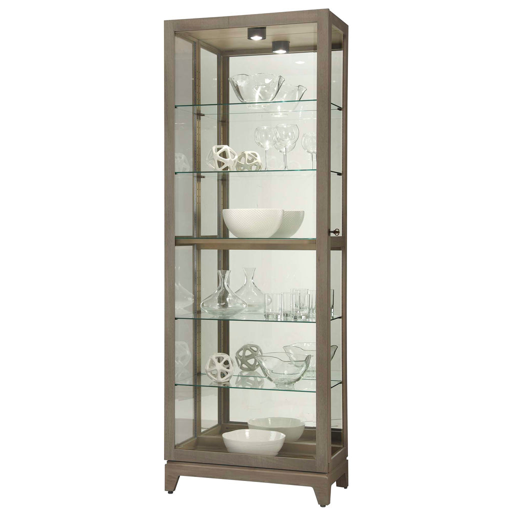 A tall glass display cabinet with decorative glassware and bowls inside.