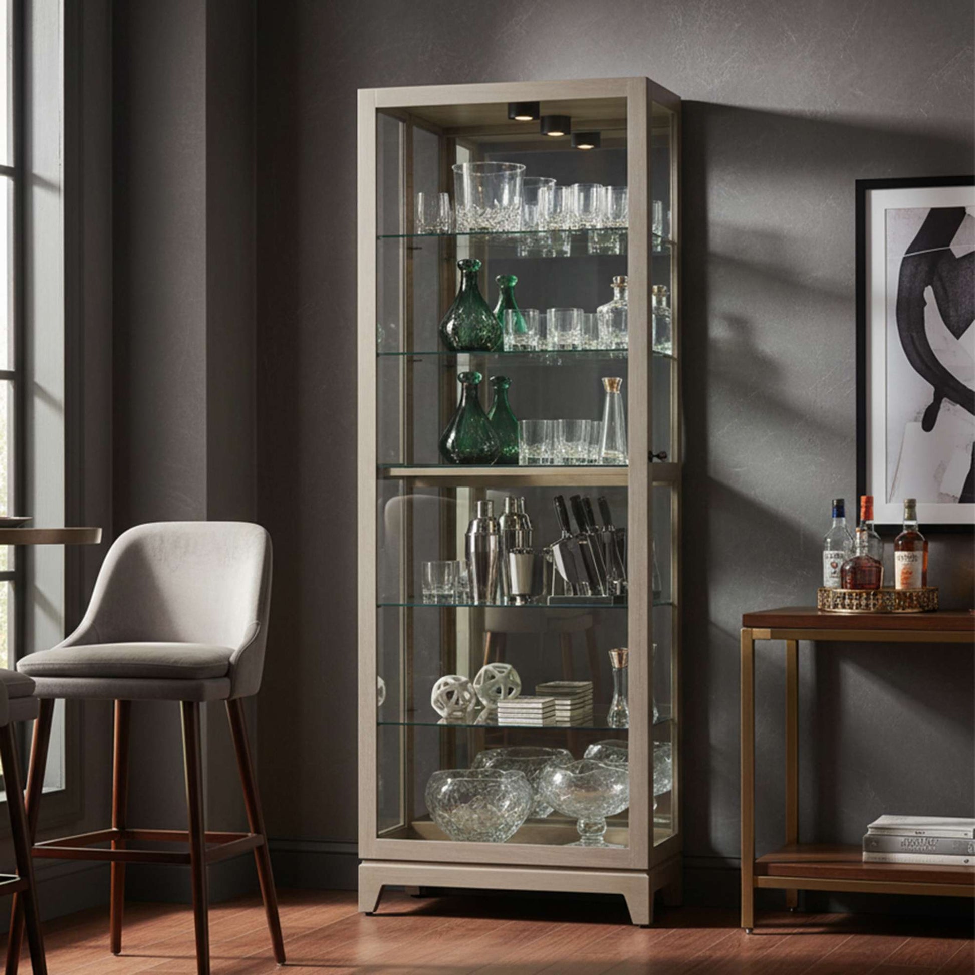 Elegant glass display cabinet showcasing various glassware and bar accessories.