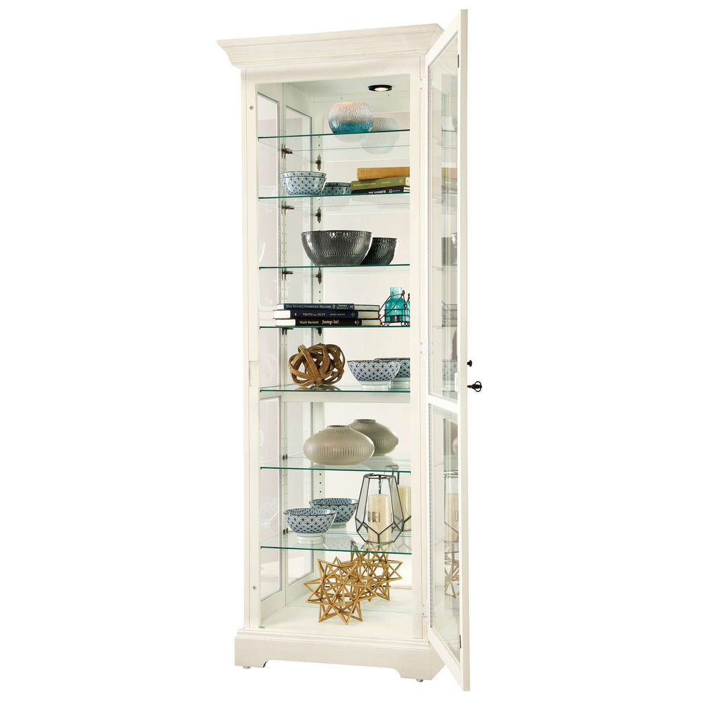 A tall display cabinet with glass shelves showcasing decorative items and home accessories.