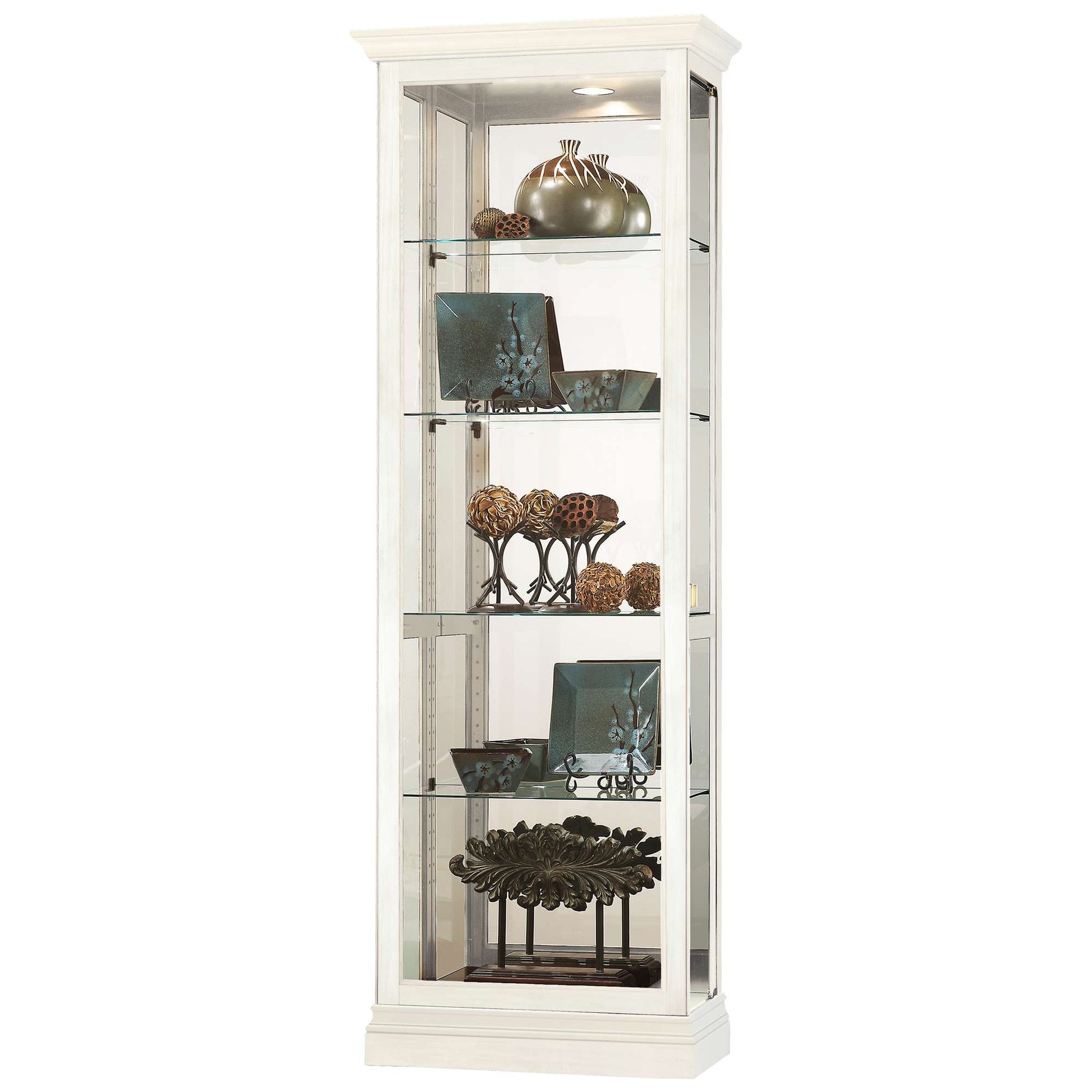 A tall, white display cabinet with glass shelves holding decorative items.