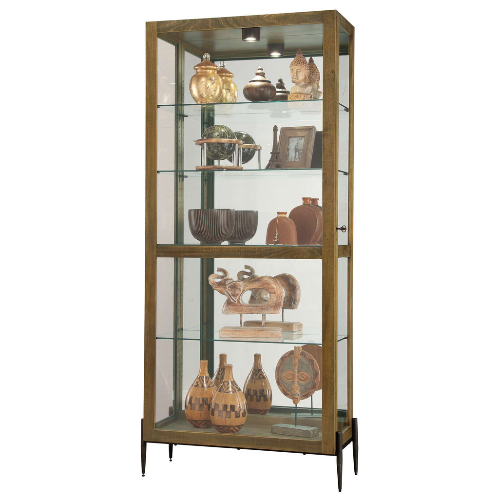 A tall glass display cabinet showcasing various decorative items and pottery.