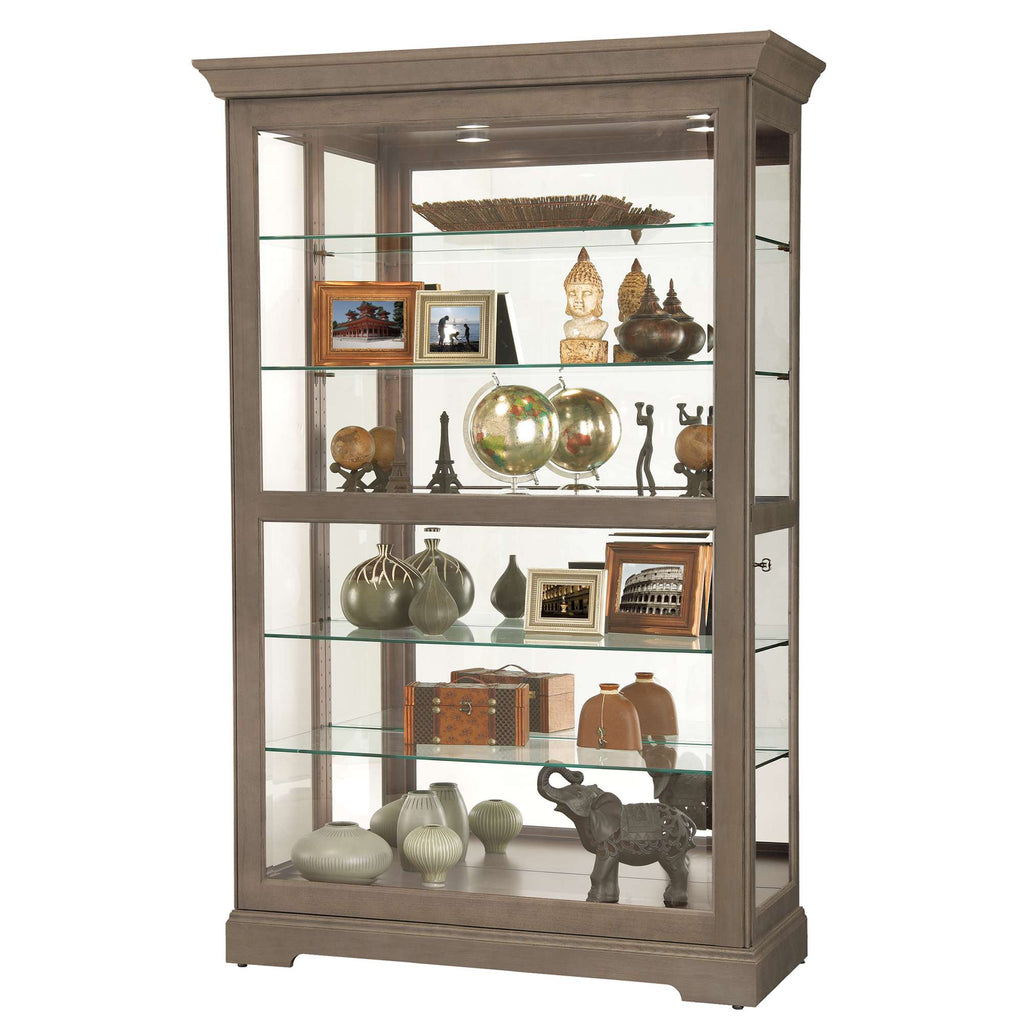 A glass-front display cabinet showcasing various decorative items and photographs.