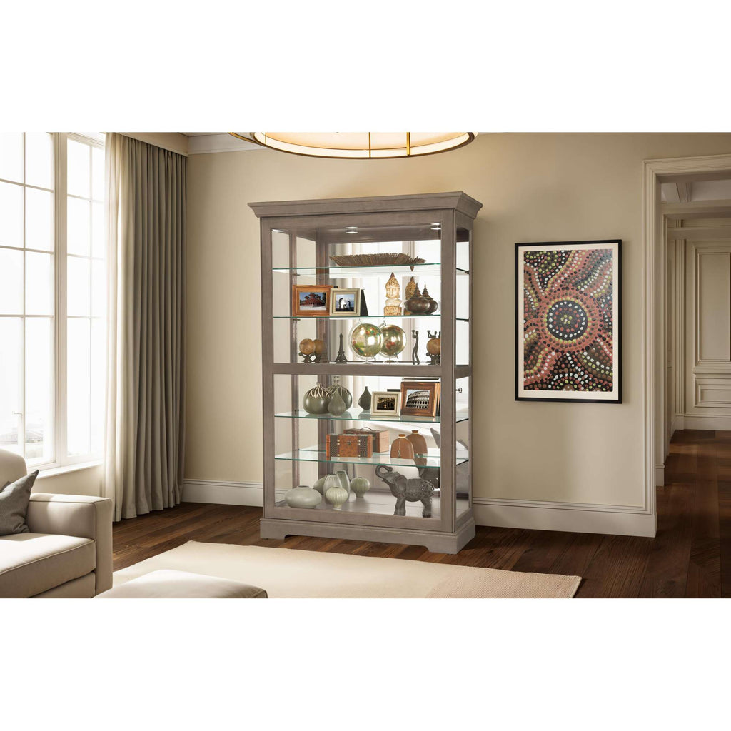 A stylish glass display cabinet showcasing decorative items and artwork in a well-lit room.