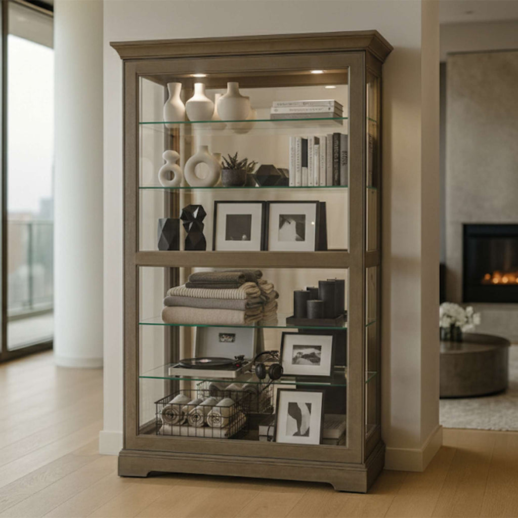 A modern display cabinet with glass shelves showcasing various decorative items and books.