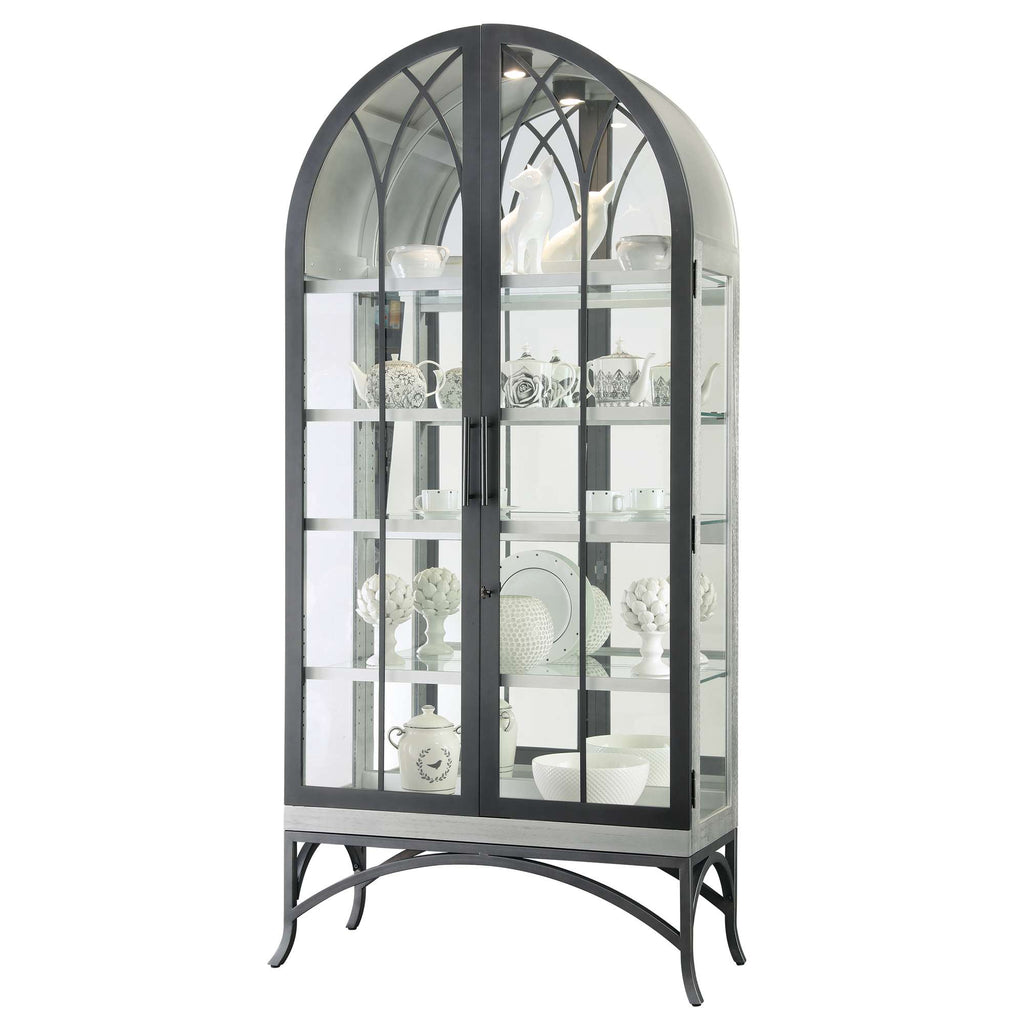 Elegant glass display cabinet with arching top and metal frame showcasing decorative items.