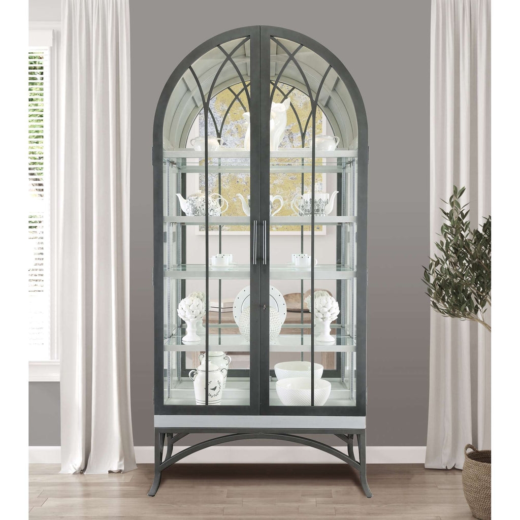 Stylish glass display cabinet with an arched top, showcasing decorative items and white ceramics.