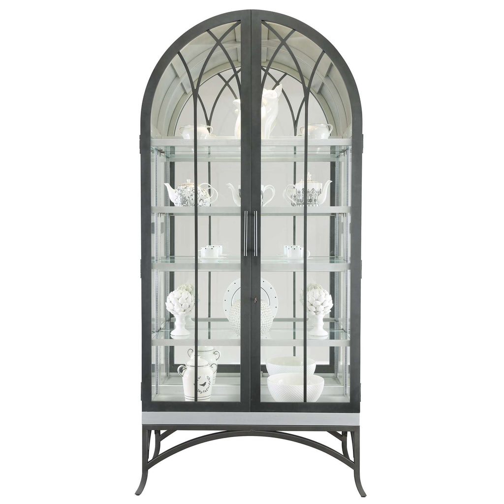 Elegant glass display cabinet with arched top showcasing decorative ceramic pieces.