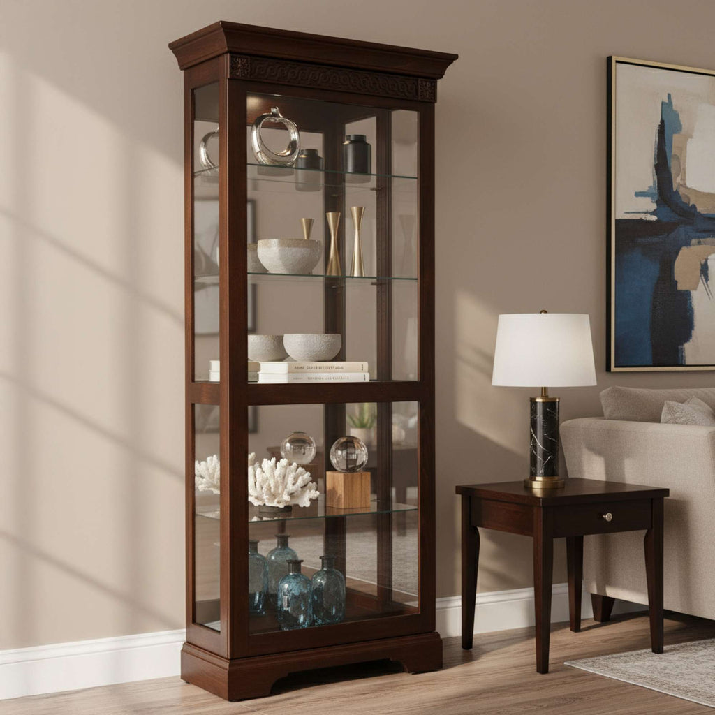 Wooden display cabinet with glass doors showcasing decorative items, beside a table lamp and accent table.