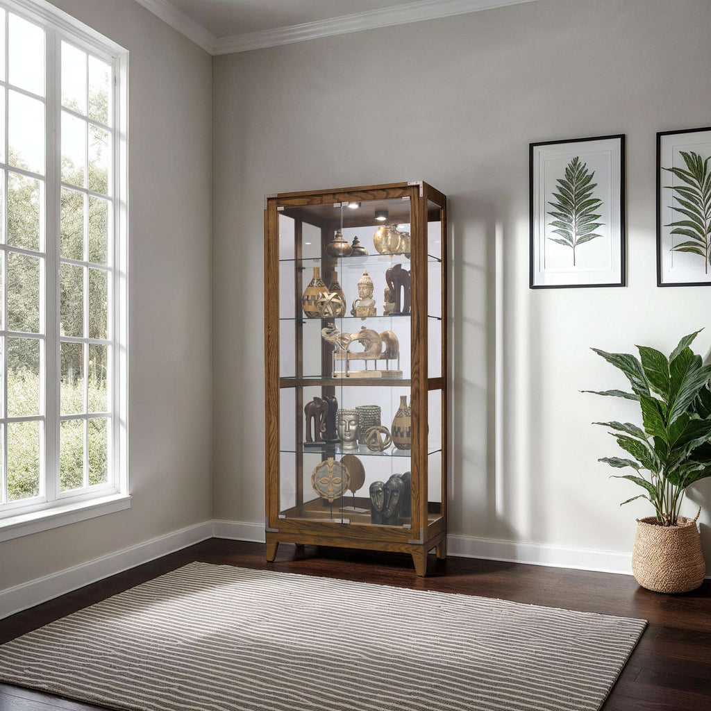 A stylish display cabinet filled with decorative items, next to a large window and potted plant.
