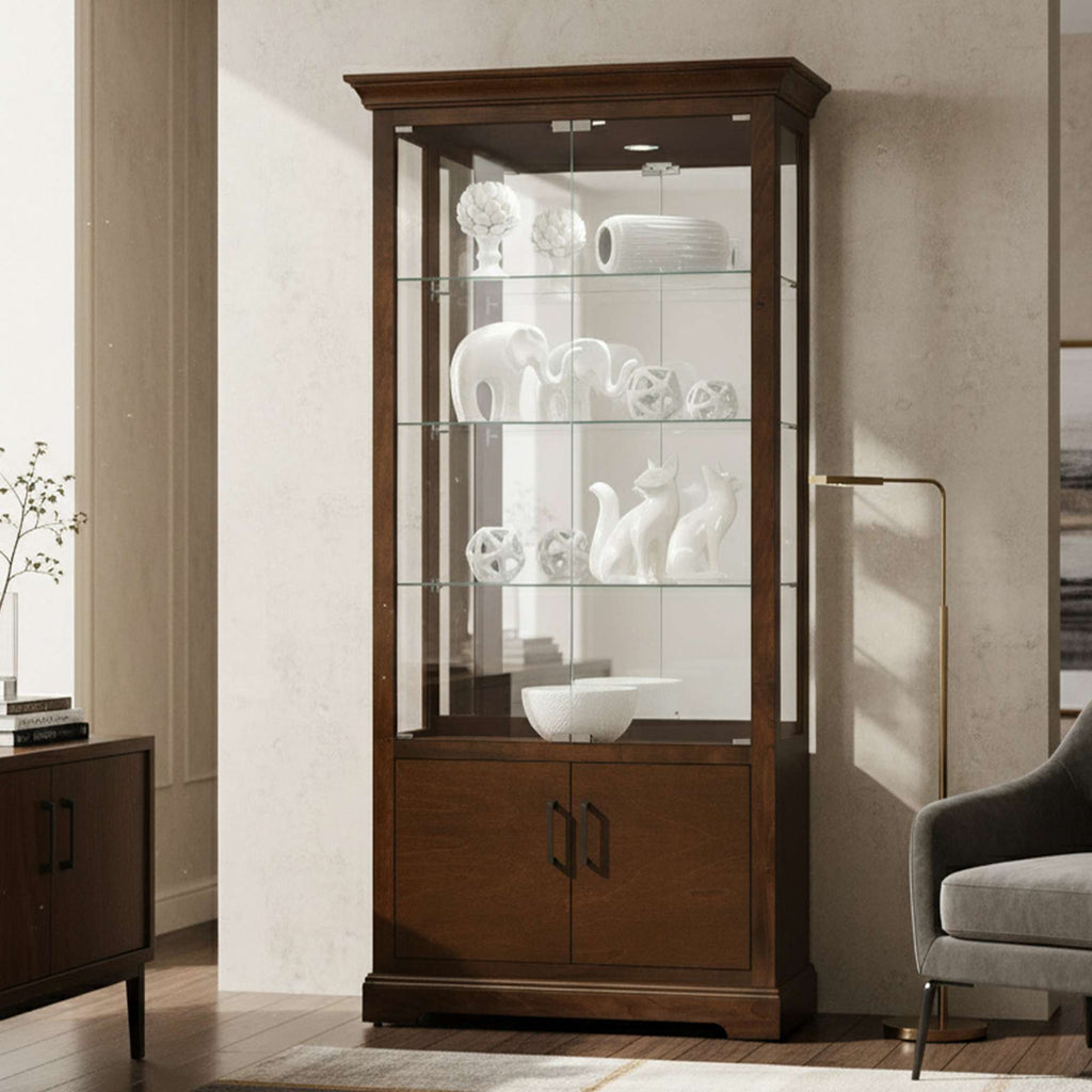 Elegant wooden display cabinet with glass shelves showcasing white decorative items.