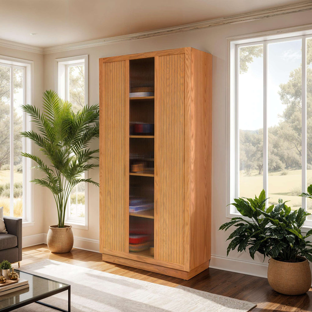 A wooden cabinet with glass doors in a bright, modern living room, surrounded by green plants.