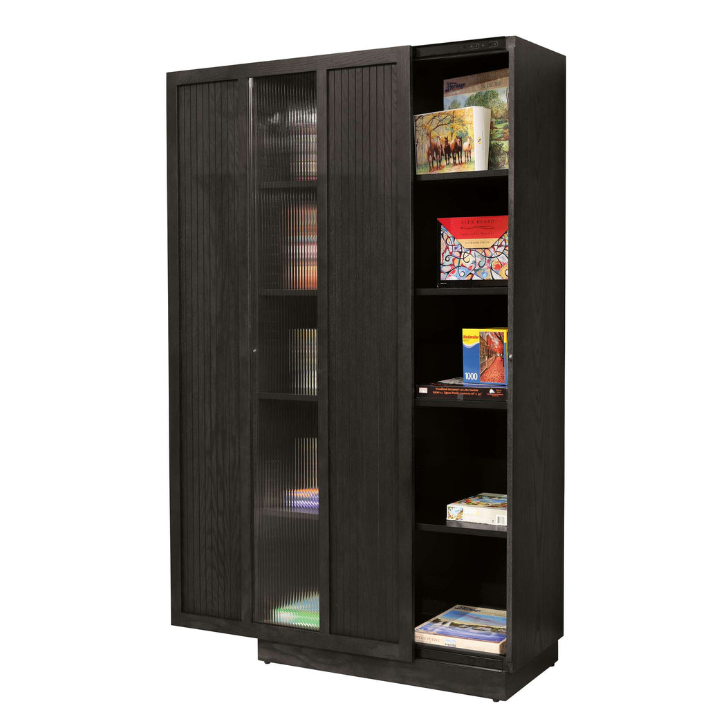 A black wooden bookshelf with glass doors displaying books and decorative items.