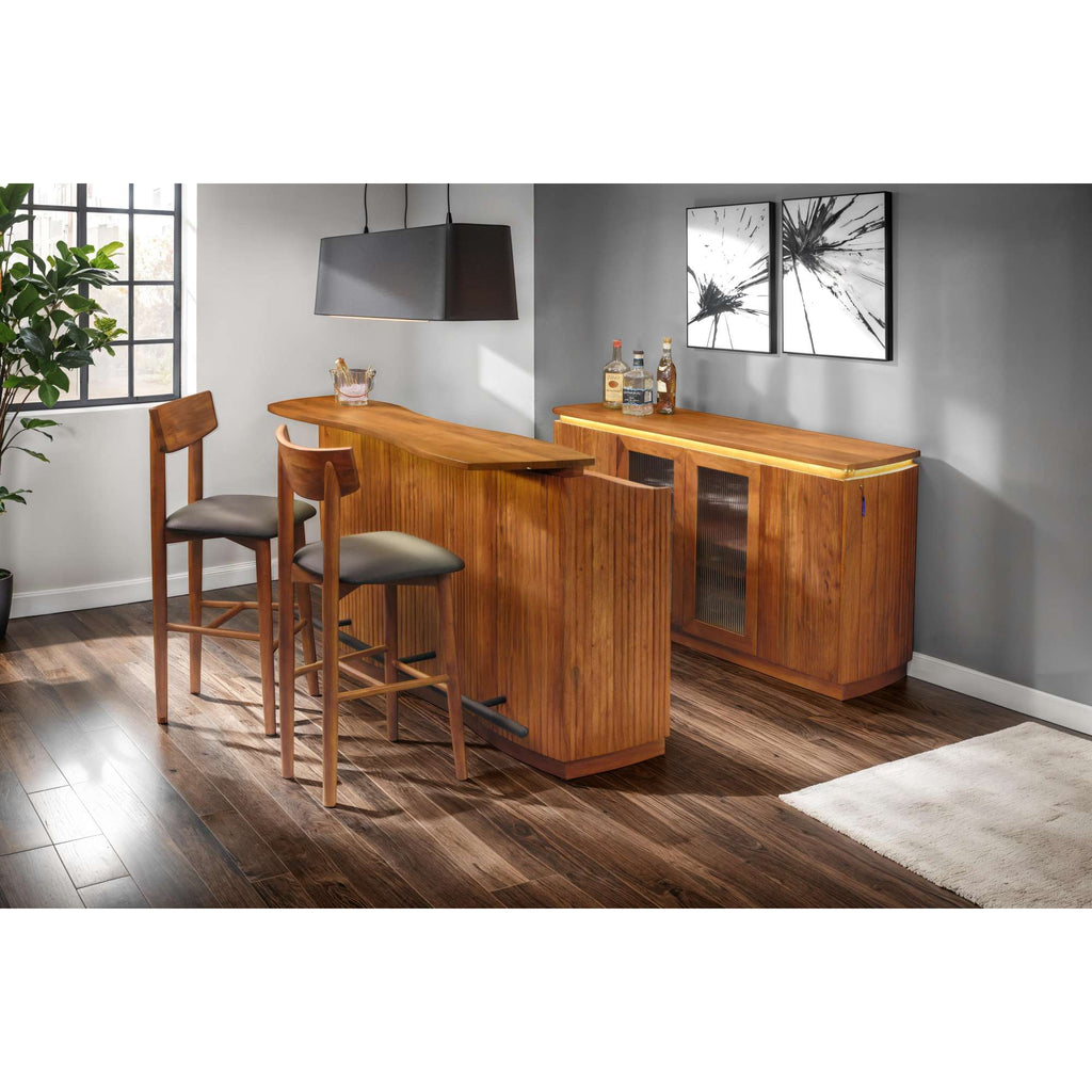 A modern home bar setup with wooden furniture, two stools, and wall art.