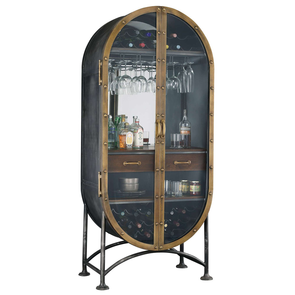 An elegant oval bar cabinet with glass doors, showcasing various bottles and glassware.