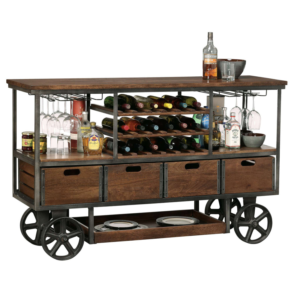 A stylish wooden bar cart with wine bottles, glassware, and storage drawers.