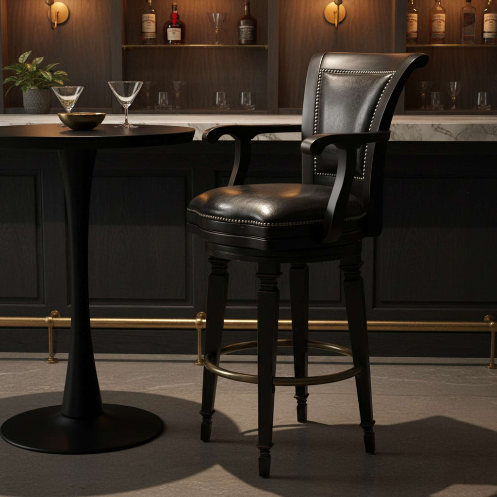 A stylish black bar stool next to a small round table in a dimly lit bar setting.