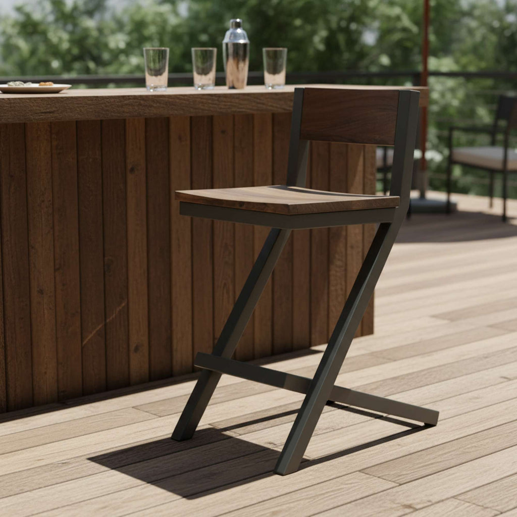 A wooden bar stool positioned beside a rustic wooden counter on a deck.