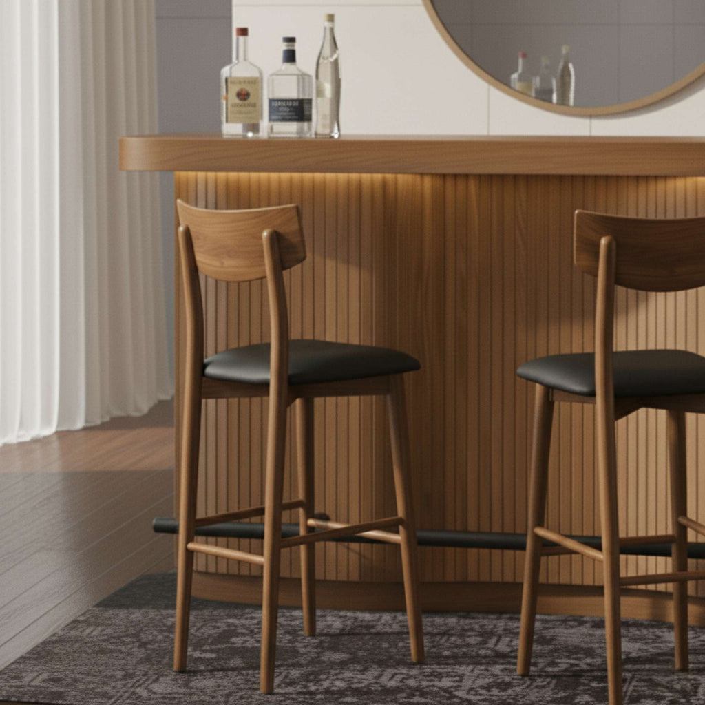 Wooden bar stools at a stylish bar with bottles in the background