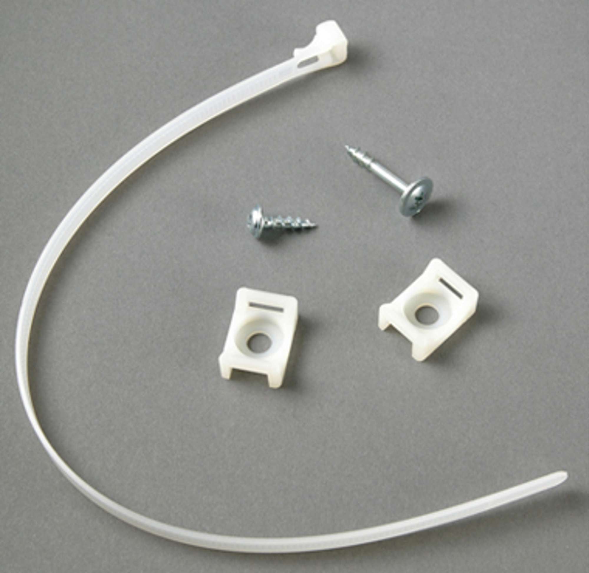 A plastic cable tie, two plastic mounts, and a metal screw on a gray background.