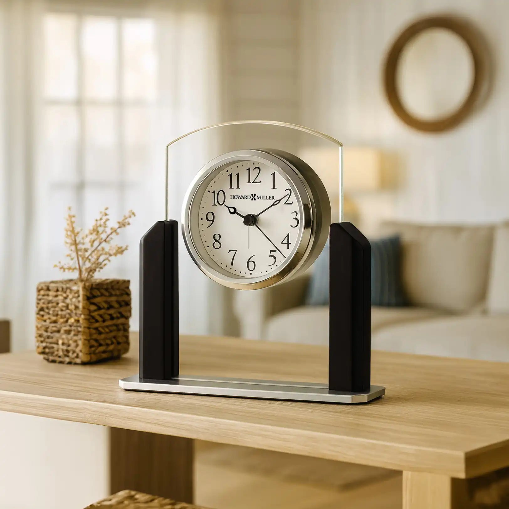 A stylish modern clock with a circular face, set on a wooden table in a cozy living room.